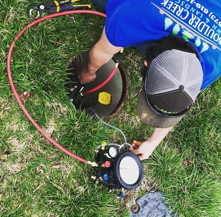 Backflow Testing | Jefferson City, MO Boulder Creek Lawn & Landscape technician provides backflow testing in Jefferson City, MO.