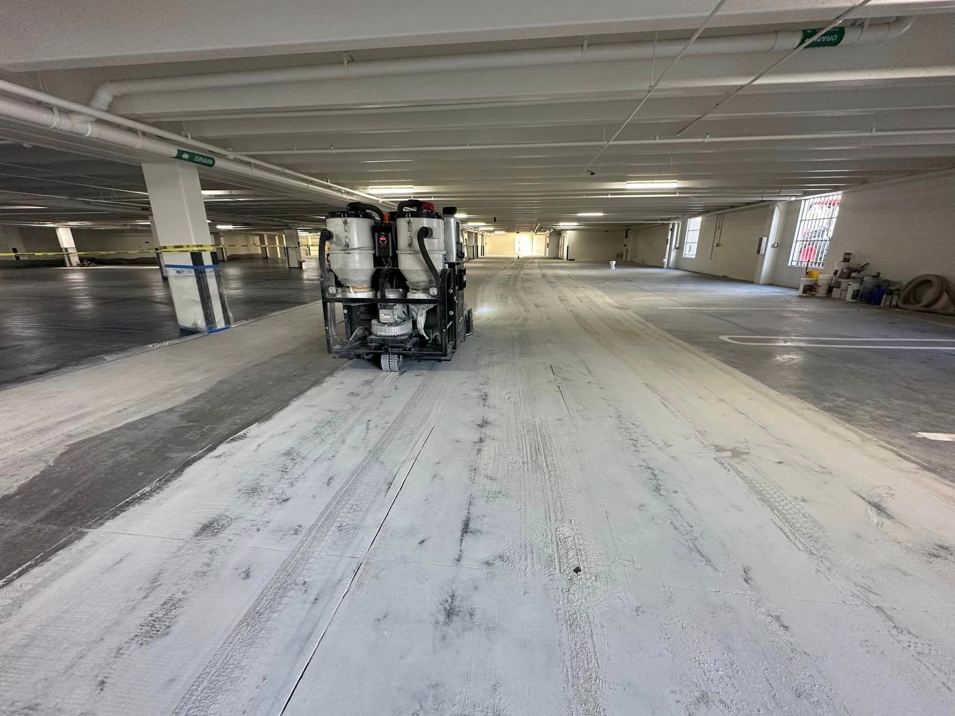 parking garage A machine is grinding the concrete in a parking garage.