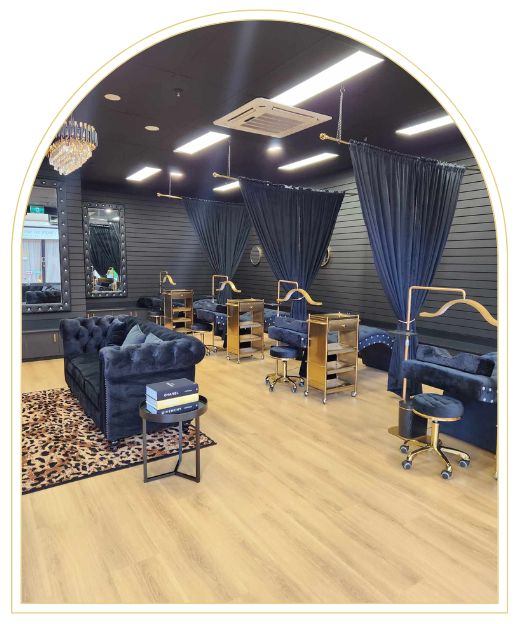 A salon with a couch , chairs , tables and curtains.