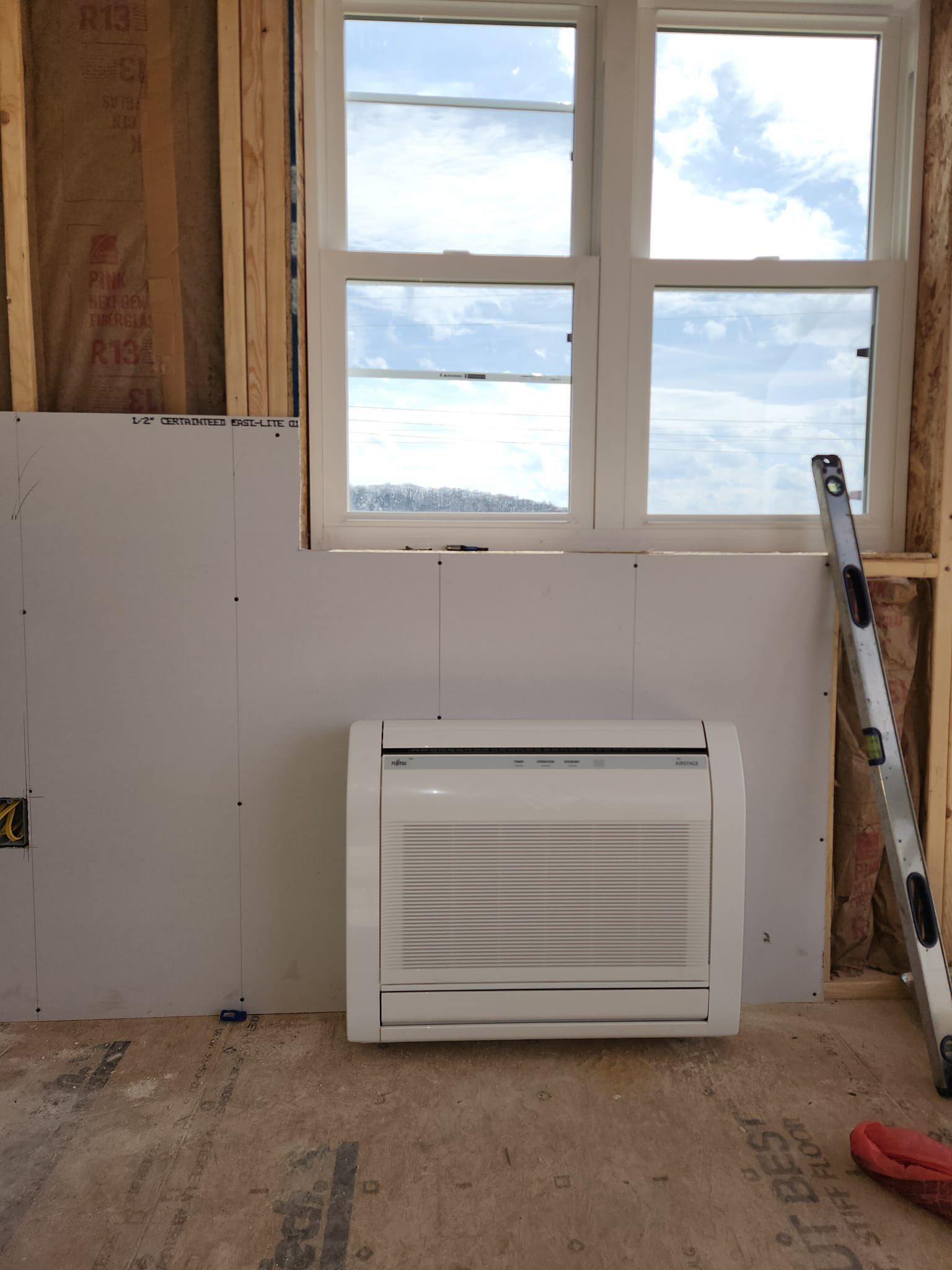 A room with a window and a ladder in it