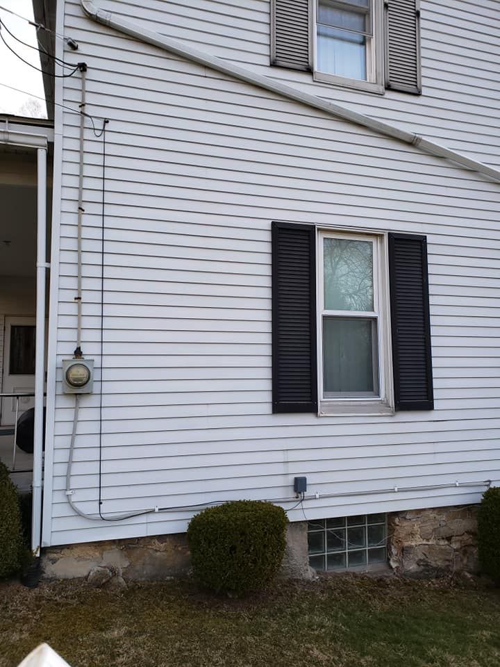 A white house with black shutters on the windows