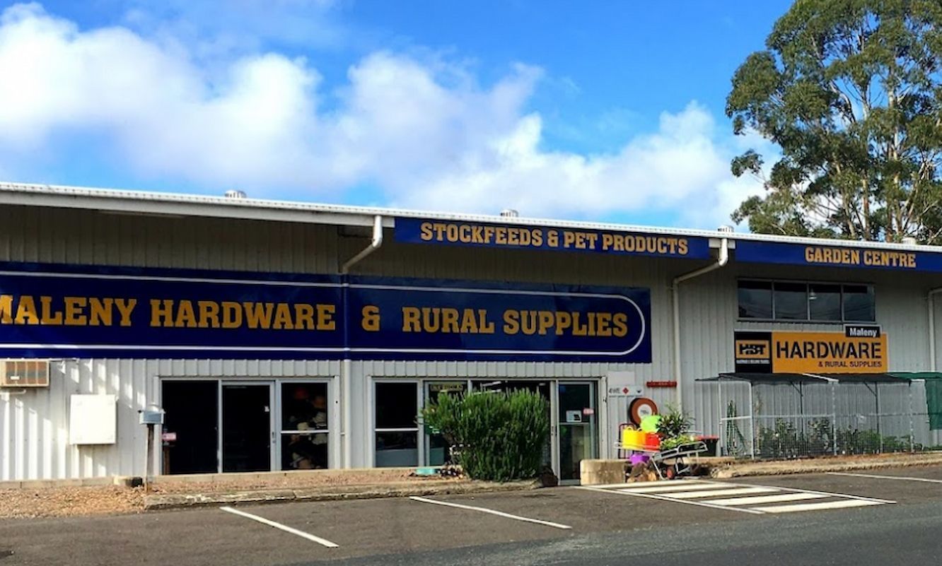 A Military Truck With Boxes In The Back Is Parked In A Parking Lot — Maleny Hardware & Rural Supplies In Maleny, QLD