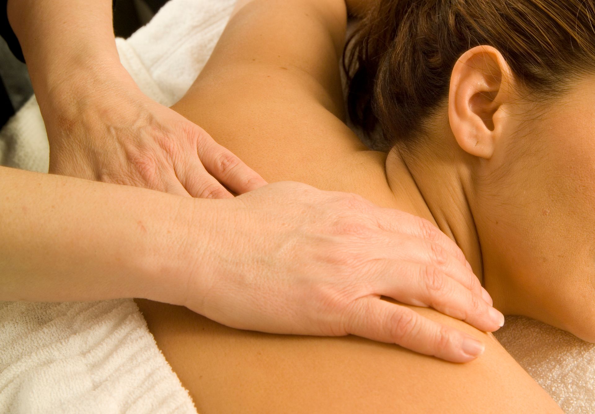 A Woman Is Getting a Massage on Her Back at a Spa — Ocean Isle Beach, NC — OIB Massage