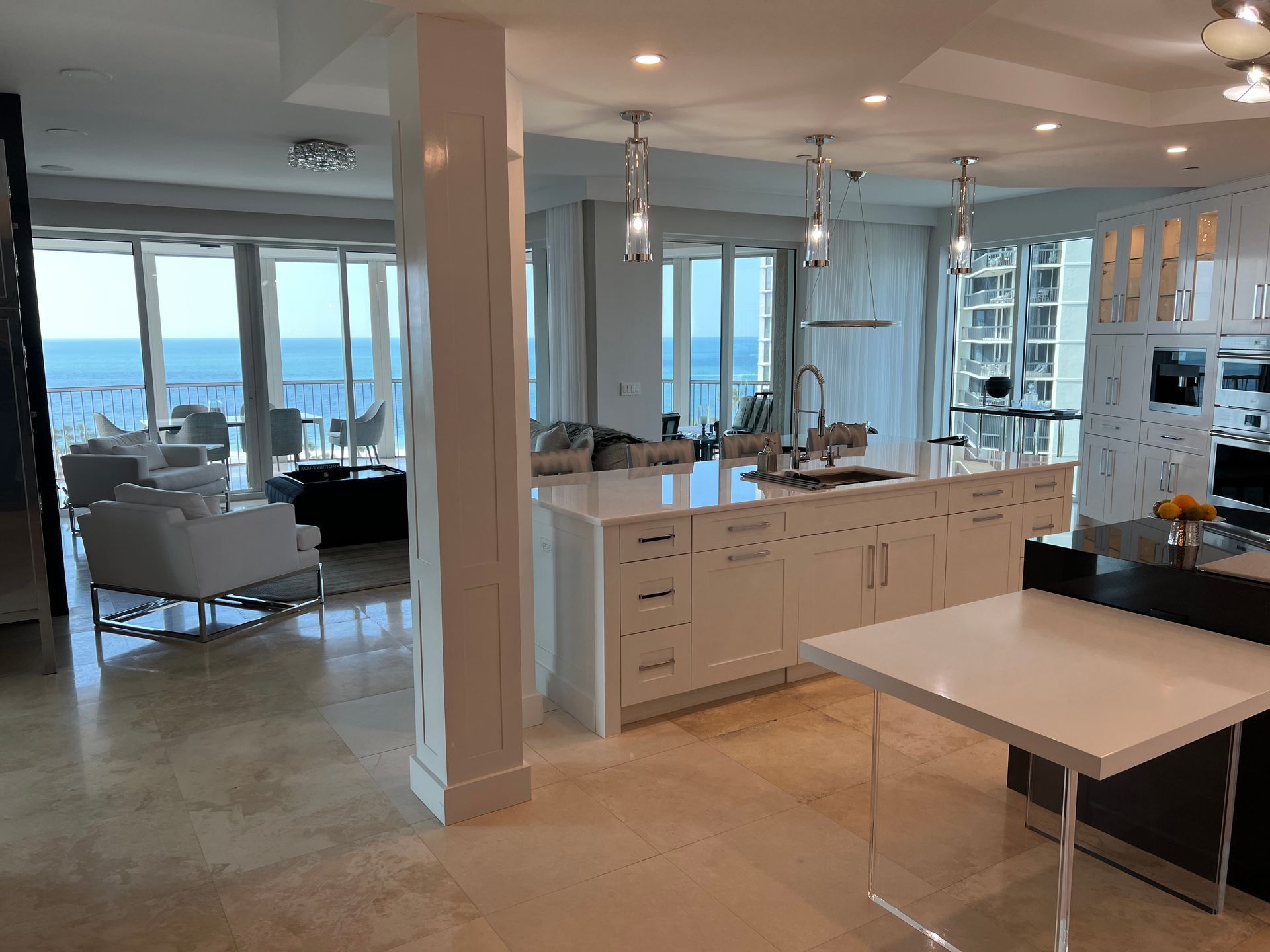 Modern kitchen and living room with ocean view through large windows