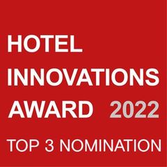 Ein rotes Schild mit der Aufschrift „Hotel Innovations Award 2022 Top 3 Nominierung“