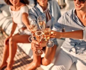 friends toasting with champagne on a yacht