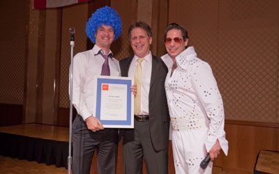 ACCJ Volunteer of the Year, Bryce Conlan, on stage receiving his award at the 2011 Champagne Ball