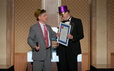 ACCJ Volunteer of the Year, Harry Sullivan, on stage receiving his award at the 2012 Champagne Ball