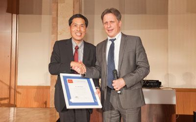 ACCJ Leader of the Year, Yuji Suzuki on stage receiving his award at the 2013 Champagne Ball.