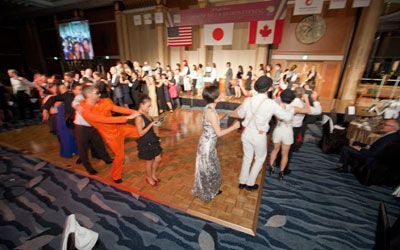 A large group of people are dancing on a dance floor