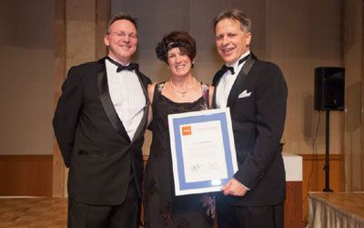 ACCJ Volunteer of the Year, Erin Sakakibara, on stage receiving her award at the 2014 Champagne Ball