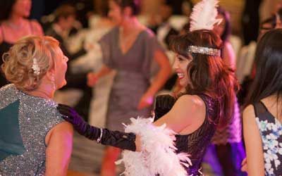A group of women are dancing together at a party.