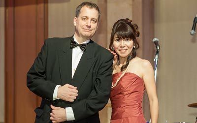 Miki Idei and Bruce McCaughan co-emceeing a gala event.
