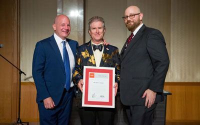 ACCJ Leader of the Year, Britt Creamer on stage receiving his award at the 2018 Champagne Ball.
