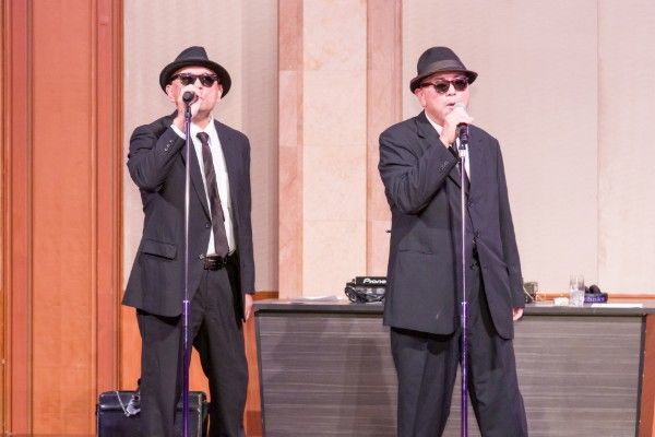 Two Blues Brothers impersonators performing on stage
