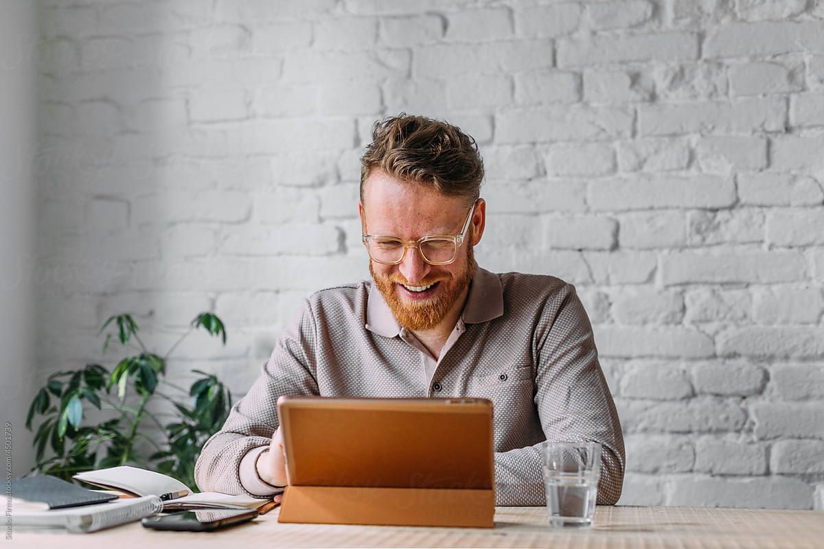 Resident working on laptop in co-working space at Park Center at Seven Oaks