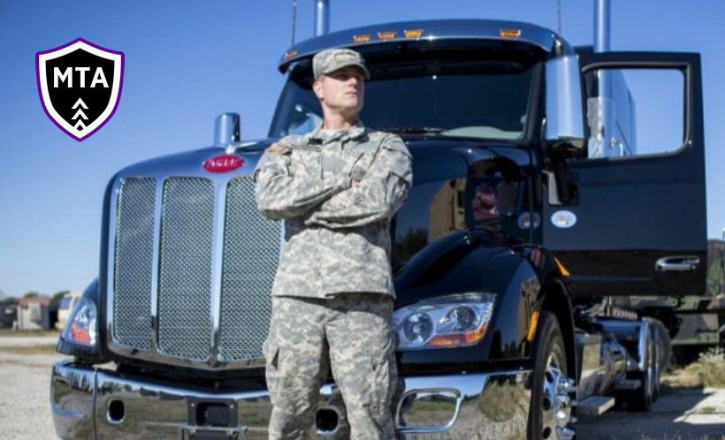 a soldier is standing in front of a truck with his arms crossed a soldier is standing in front of a truck with his arms crossed
