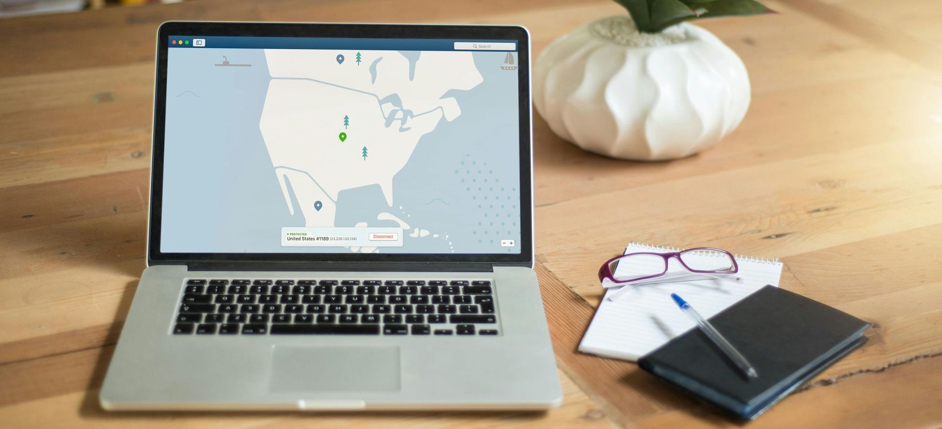 Open laptop displaying a map beside glasses and notes, illustrating the digital planning resources used by chartered financial planners in Rayside.