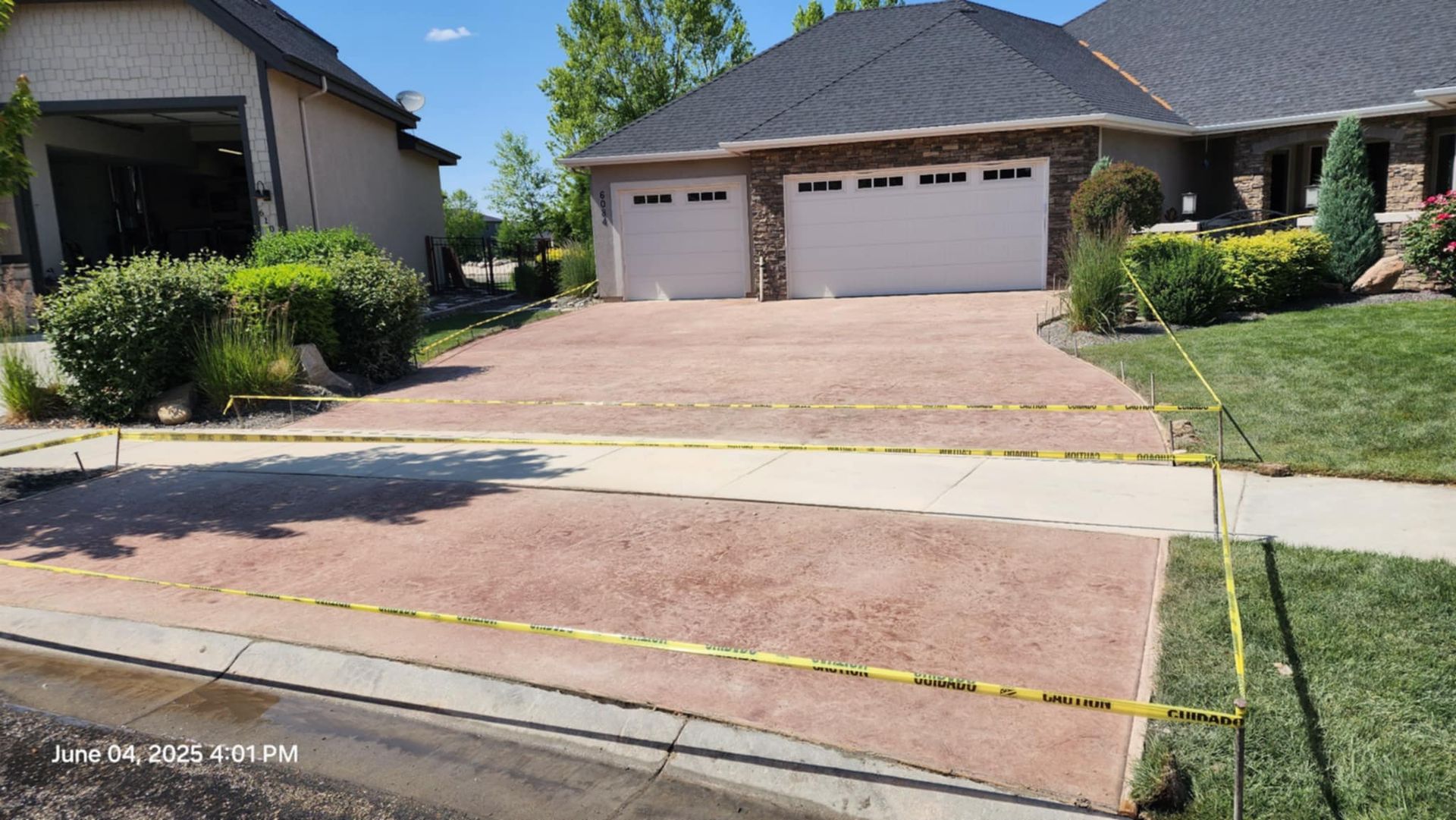 Suburban house with a three-car garage and a sloped driveway to the street