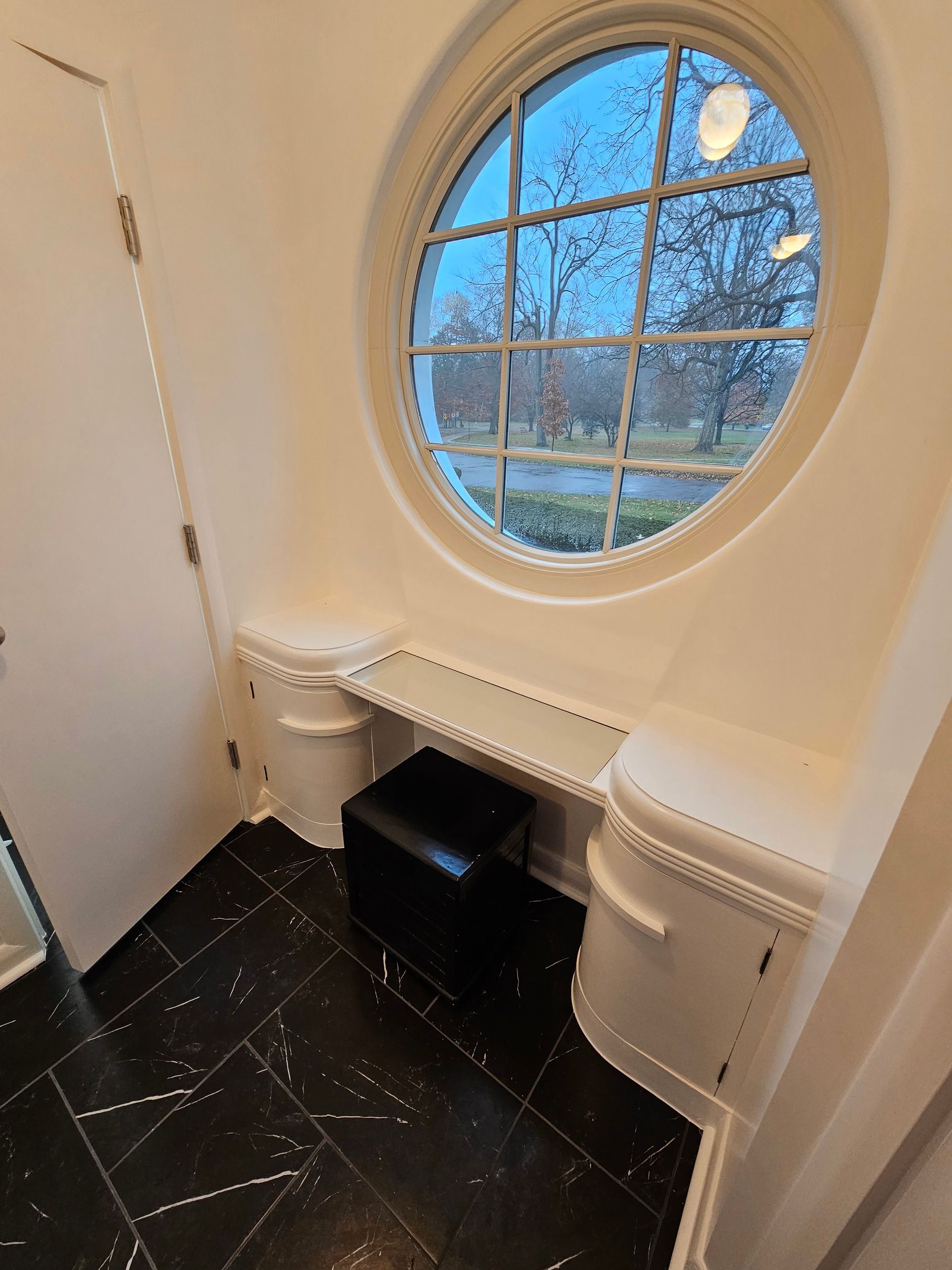 There is a round window in the middle of the room.