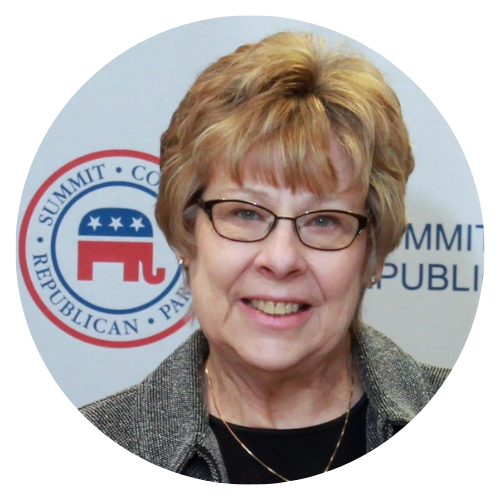 Woman with glasses, smiling, in front of a Republican Party event logo.