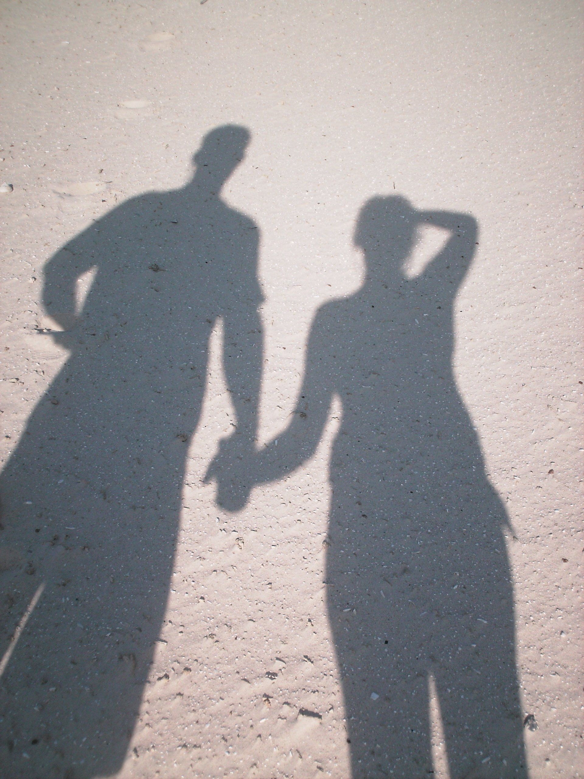 A shadow of a man and a woman holding hands