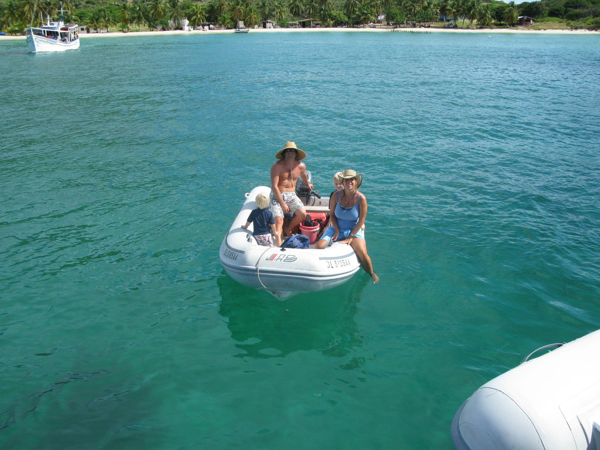 A group of people are sitting in a boat in the water