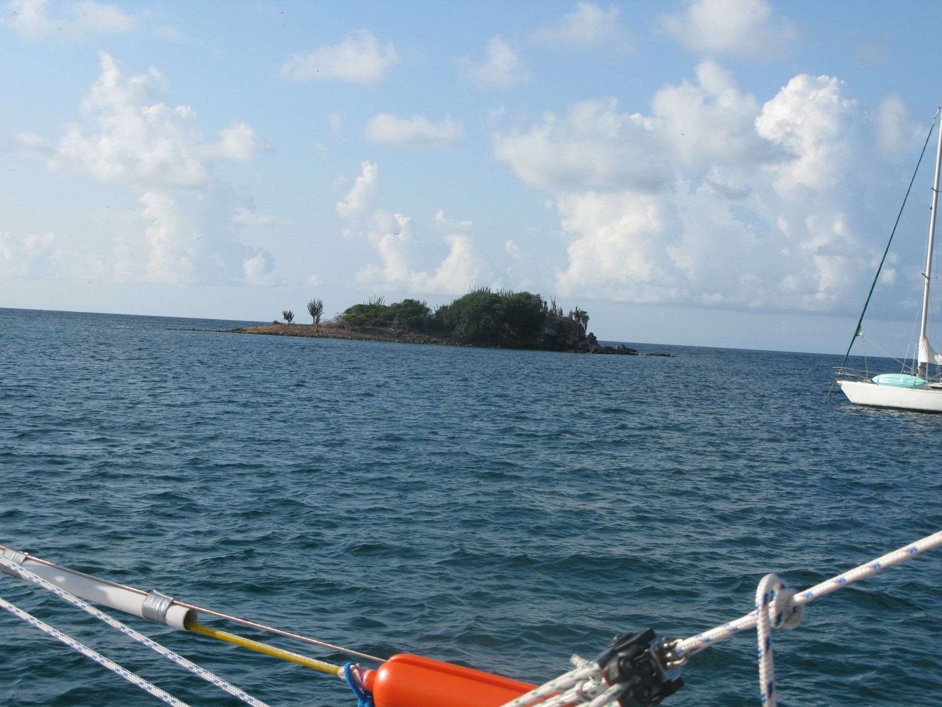 A small island in the middle of a large body of water