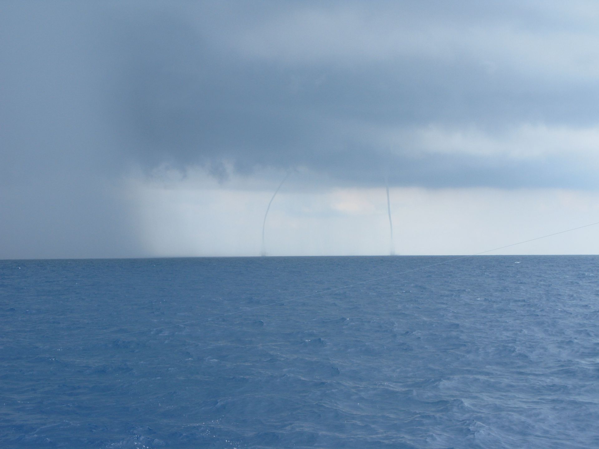 A large body of water with a cloudy sky in the background