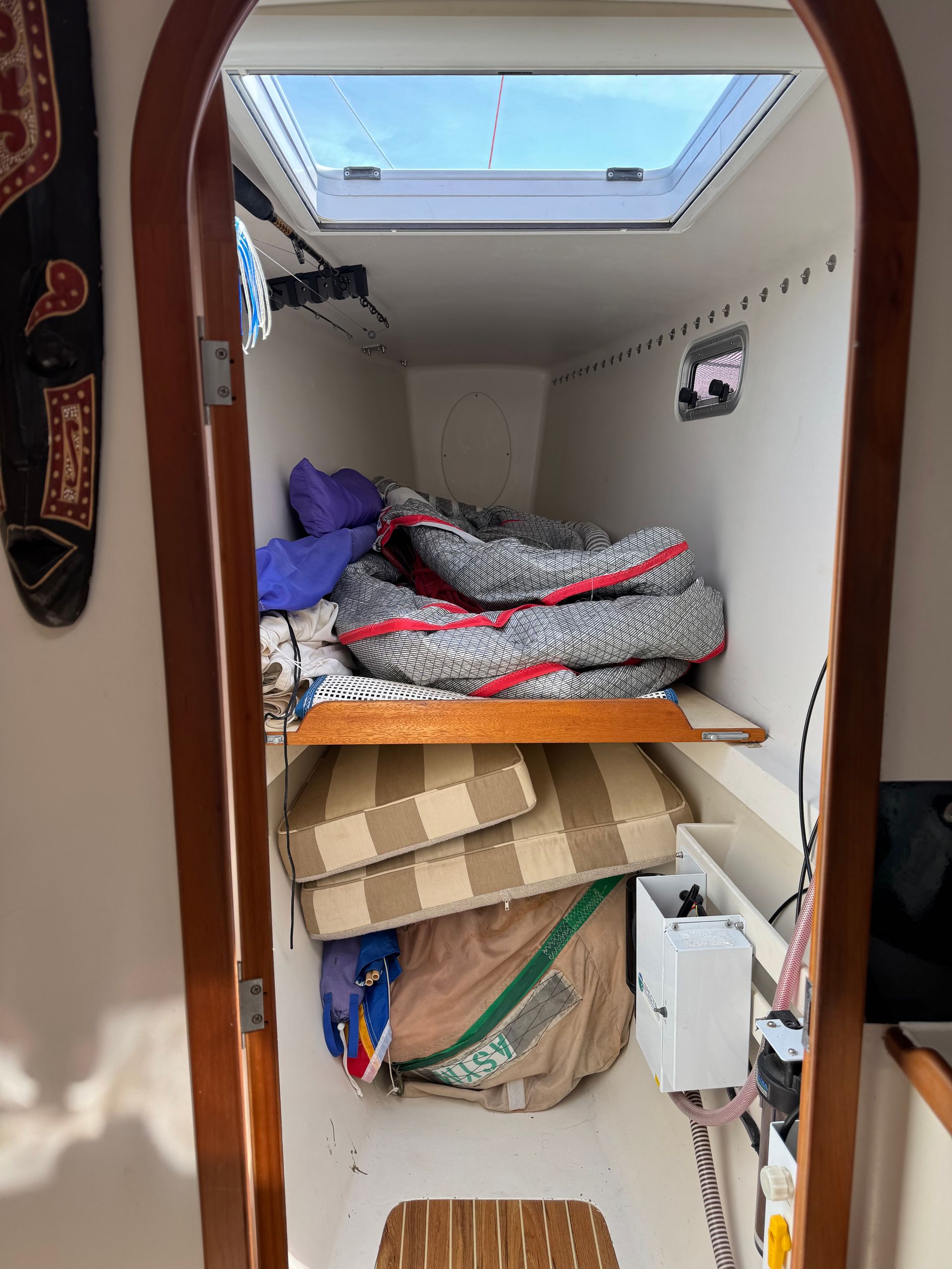 Chris White performance sailing catamaran Atlantic 48 ZEN private listing Rhode Island forward single berth, sail stowage and watermaker Spectra