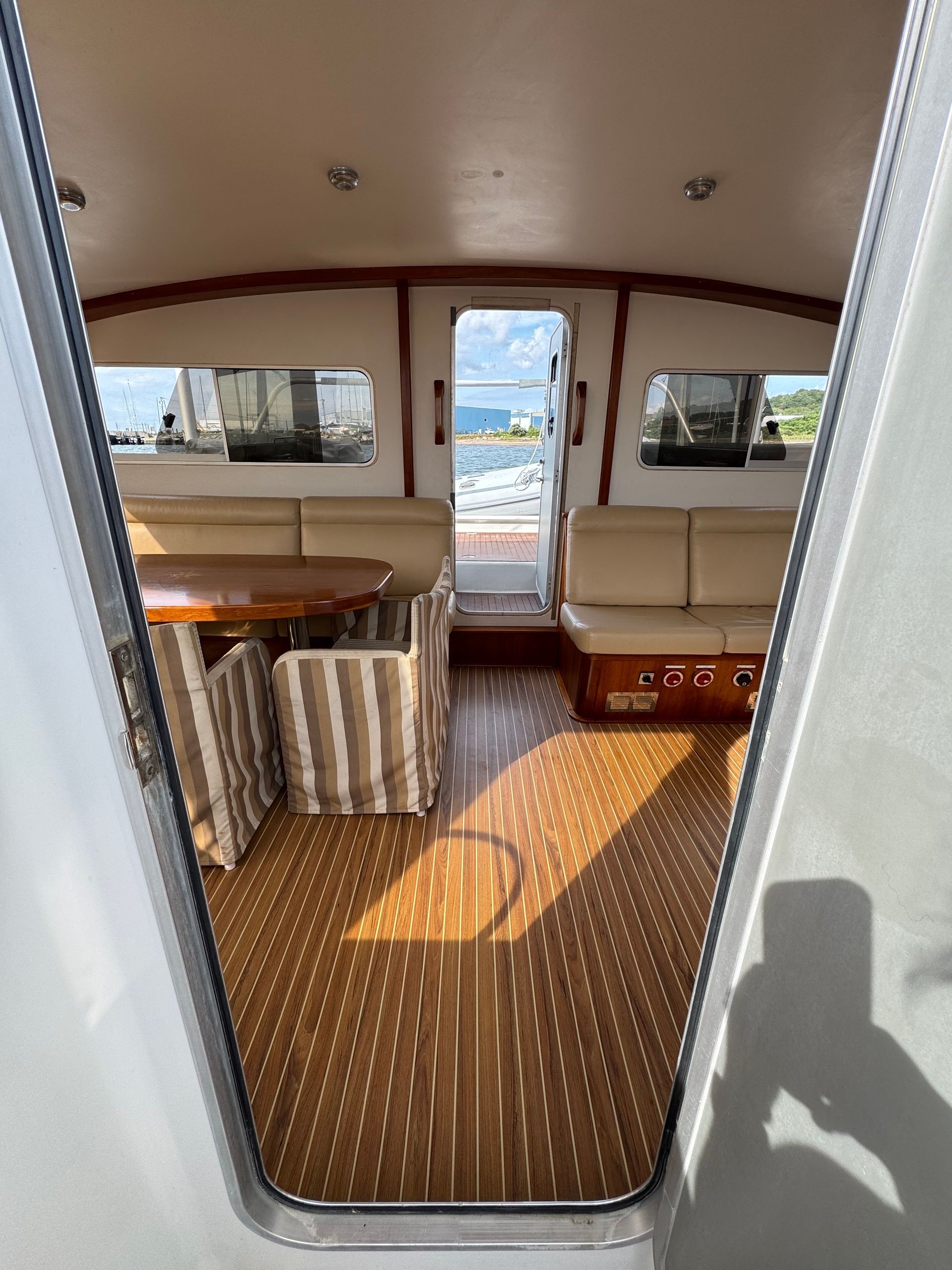 Chris White performance catamaran private listing Rhode Island main salon bridgedeck facing aft deck