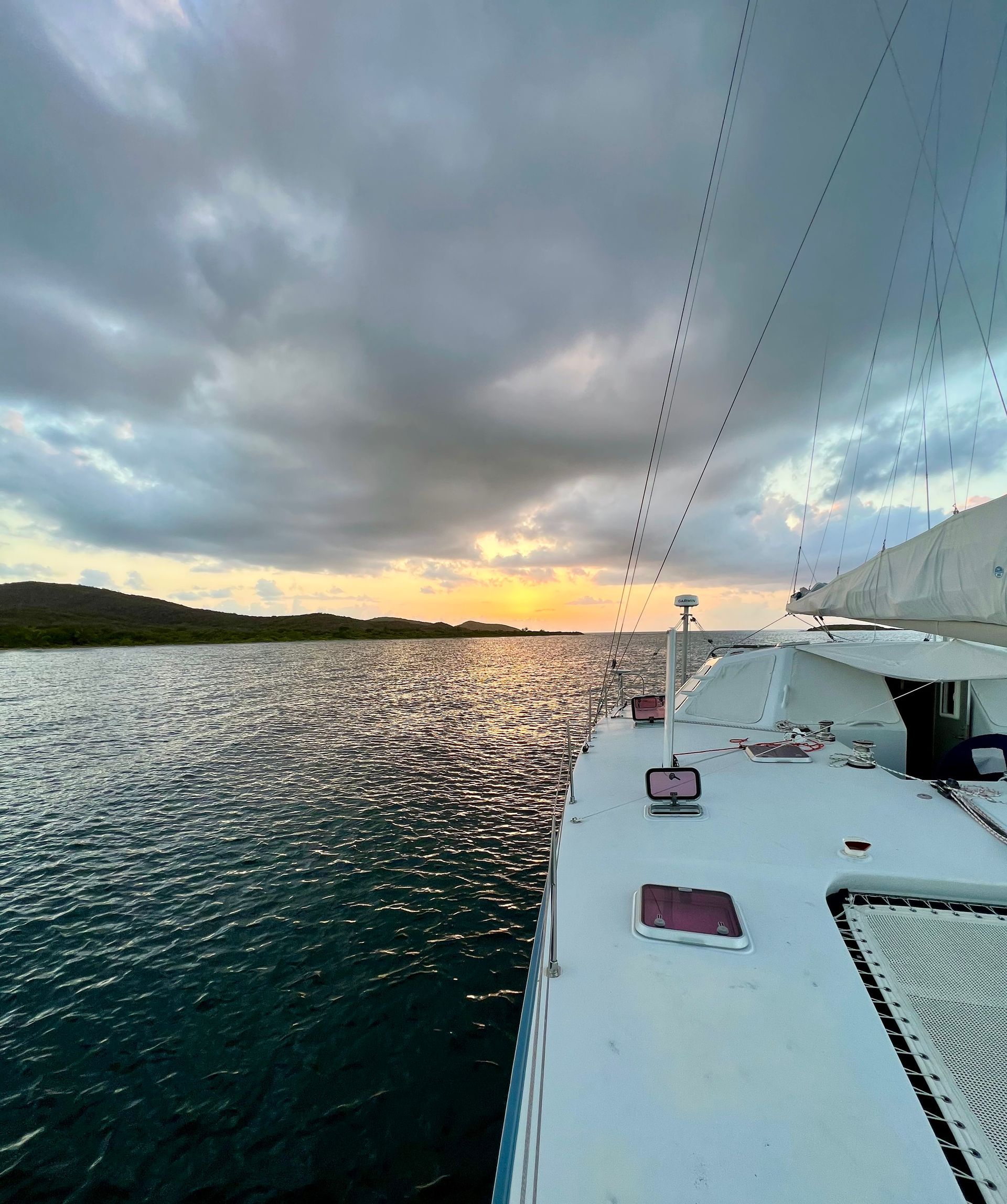 Chris White performance sailing catamaran Atlantic 48 ZEN private listing Rhode Island starboard deck with starlink and garmin at sunset