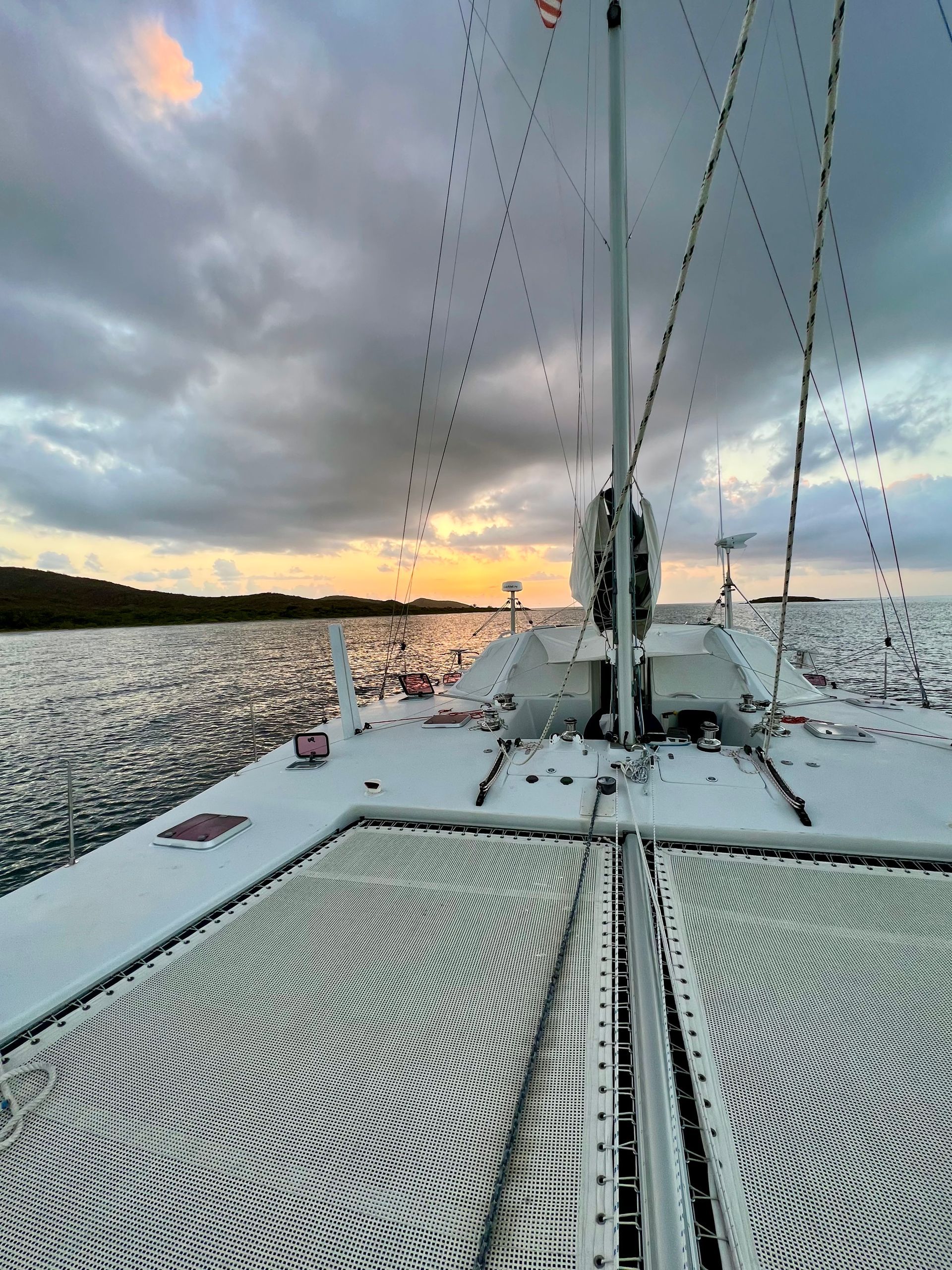 Chris White performance sailing catamaran Atlantic 48 ZEN private listing Rhode Island trampolines and true forward cockpit at sunset