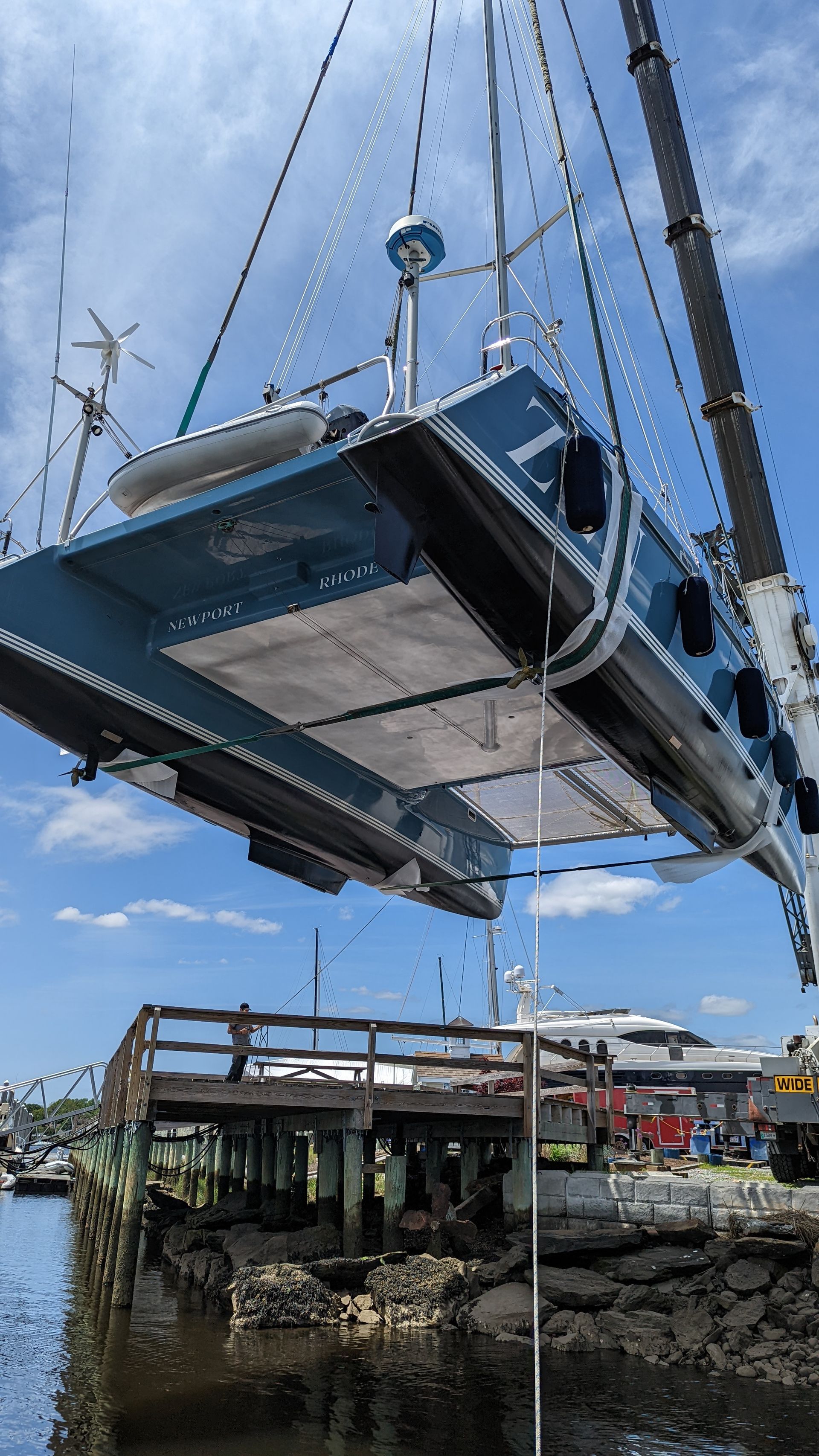 Chris White performance sailing catamaran Atlantic 48 ZEN private listing Rhode Island underneath bridge deck with hulls in crane