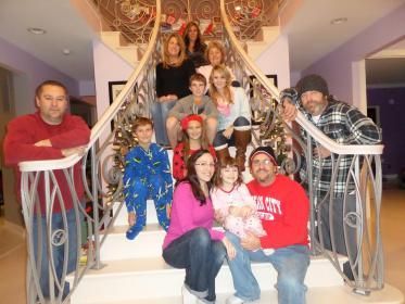 A group of people are posing for a picture on a set of stairs.