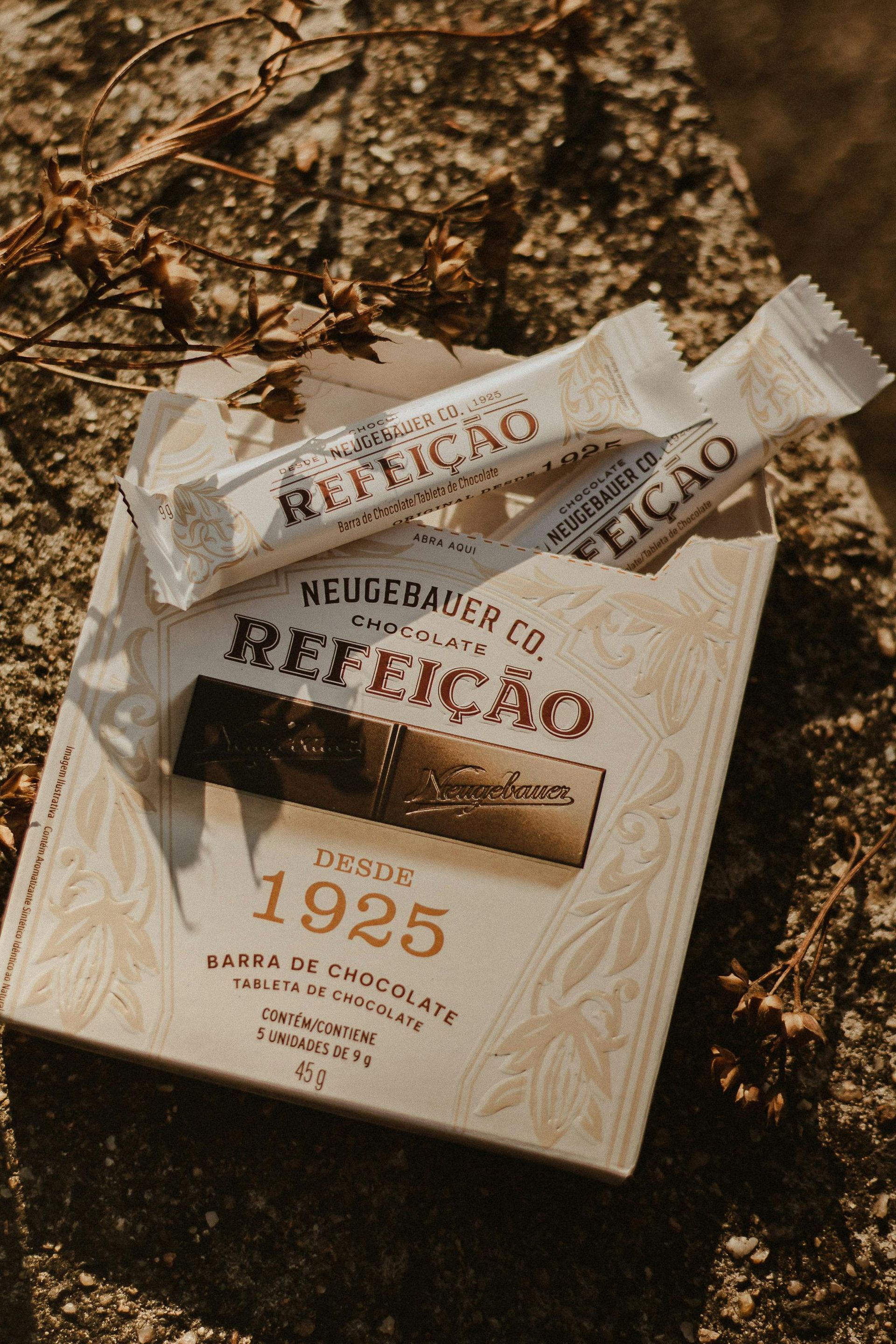 Perfume bottle and packaging on autumn leaves, labeled “Ritual” and “1925”