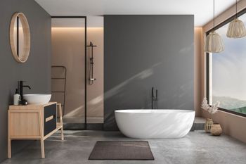 Bagno moderno di colore grigio con vasca freestanding, doccia in vetro, mobile lavabo in legno e specchio rotondo.