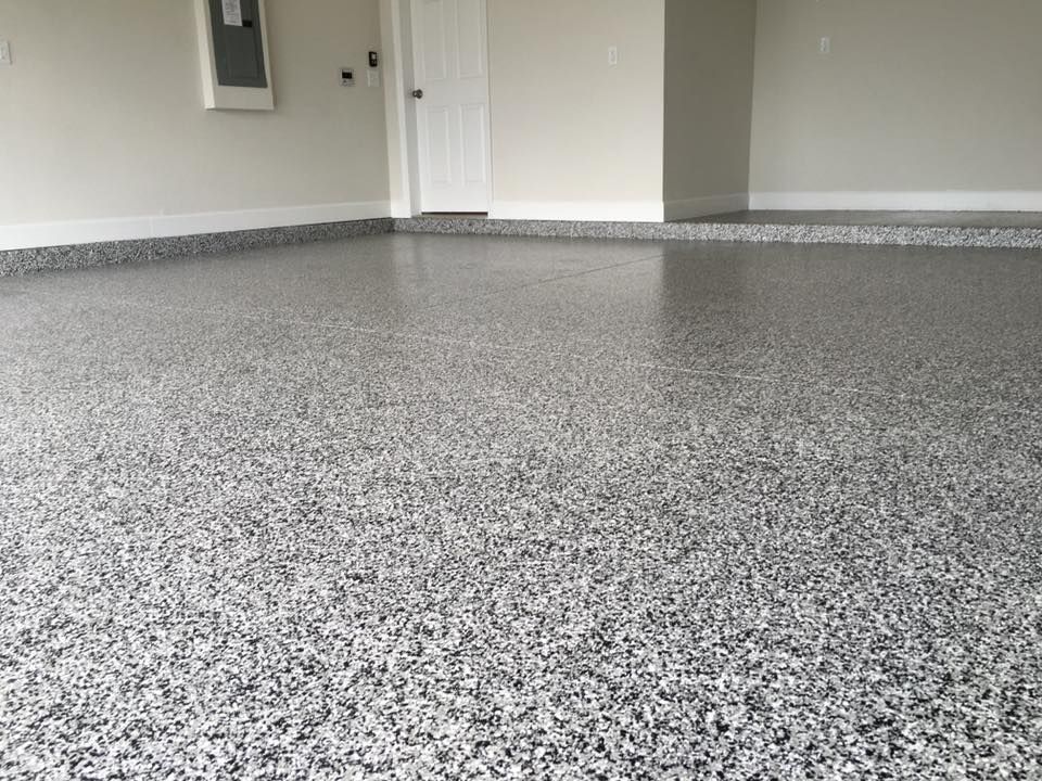 Close look at a gray and neutral epoxy finish on a residential garage floor in Jacksonville Florida home.  Installation completed by Garage Kings LLC 