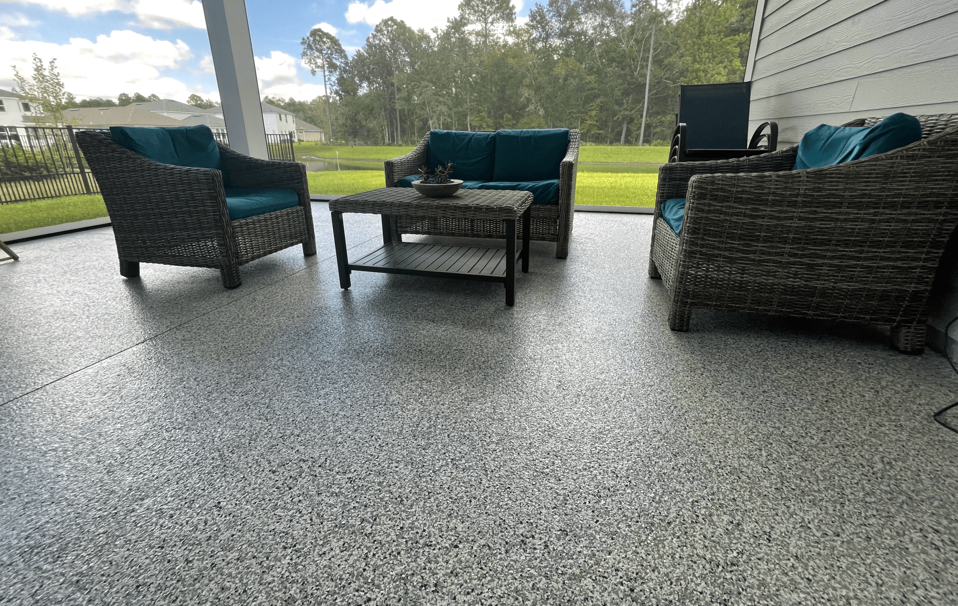 Gray colored epoxy flooring on covered Jacksonville porch.