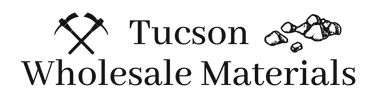 Tucson Wholesale Materials logo with crossed pickaxes and rocks in black and gray