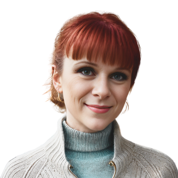 Woman with red hair and bangs, smiling, wearing a light gray sweater and blue turtleneck.