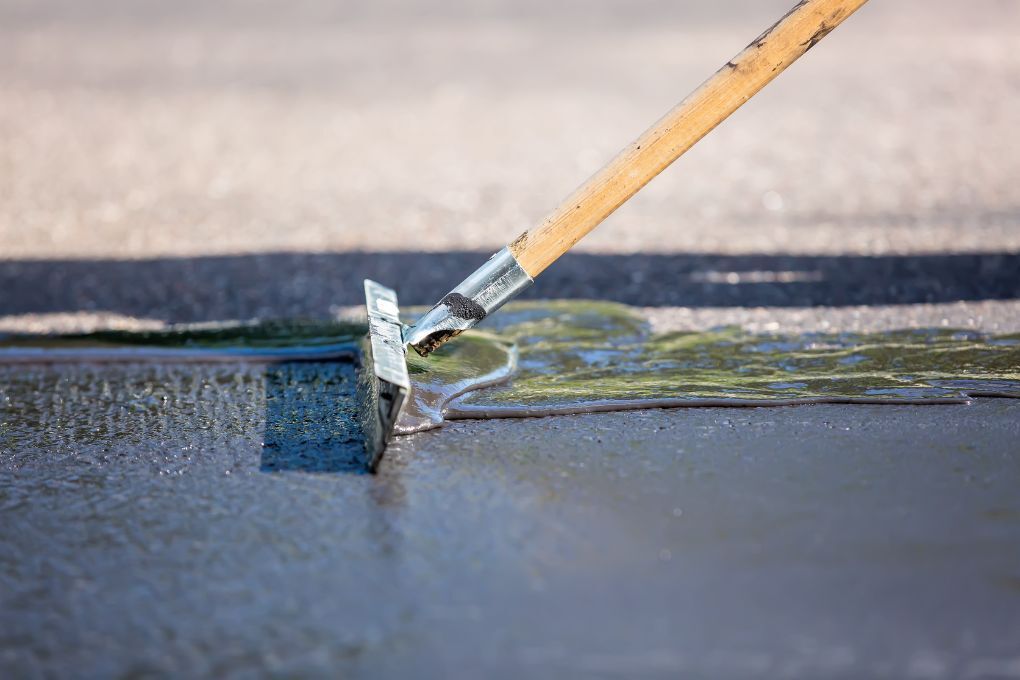 Driveway Coventry brushing sealant onto a driveway