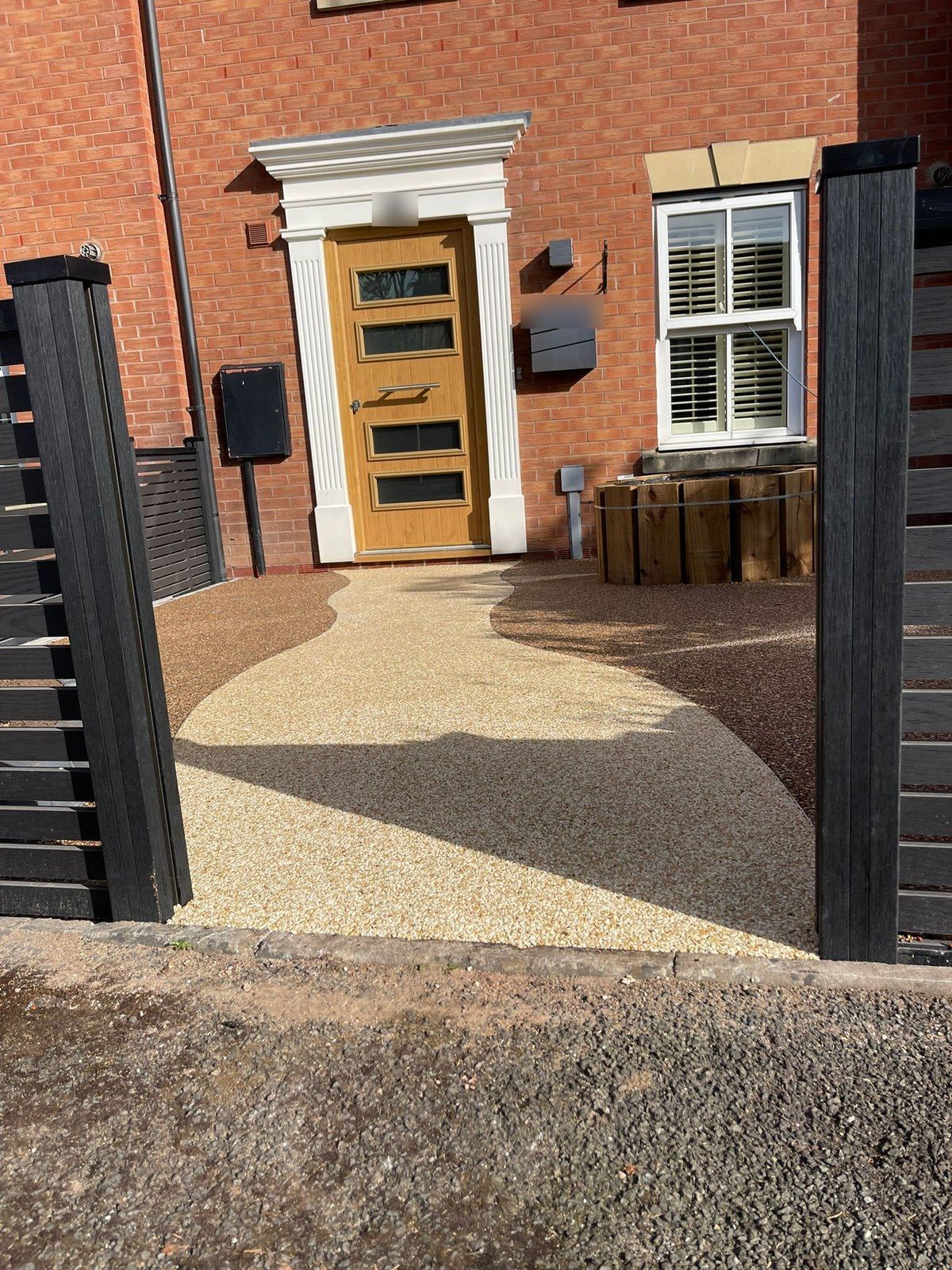 Golden resin bound path curving to a front door in Warwick