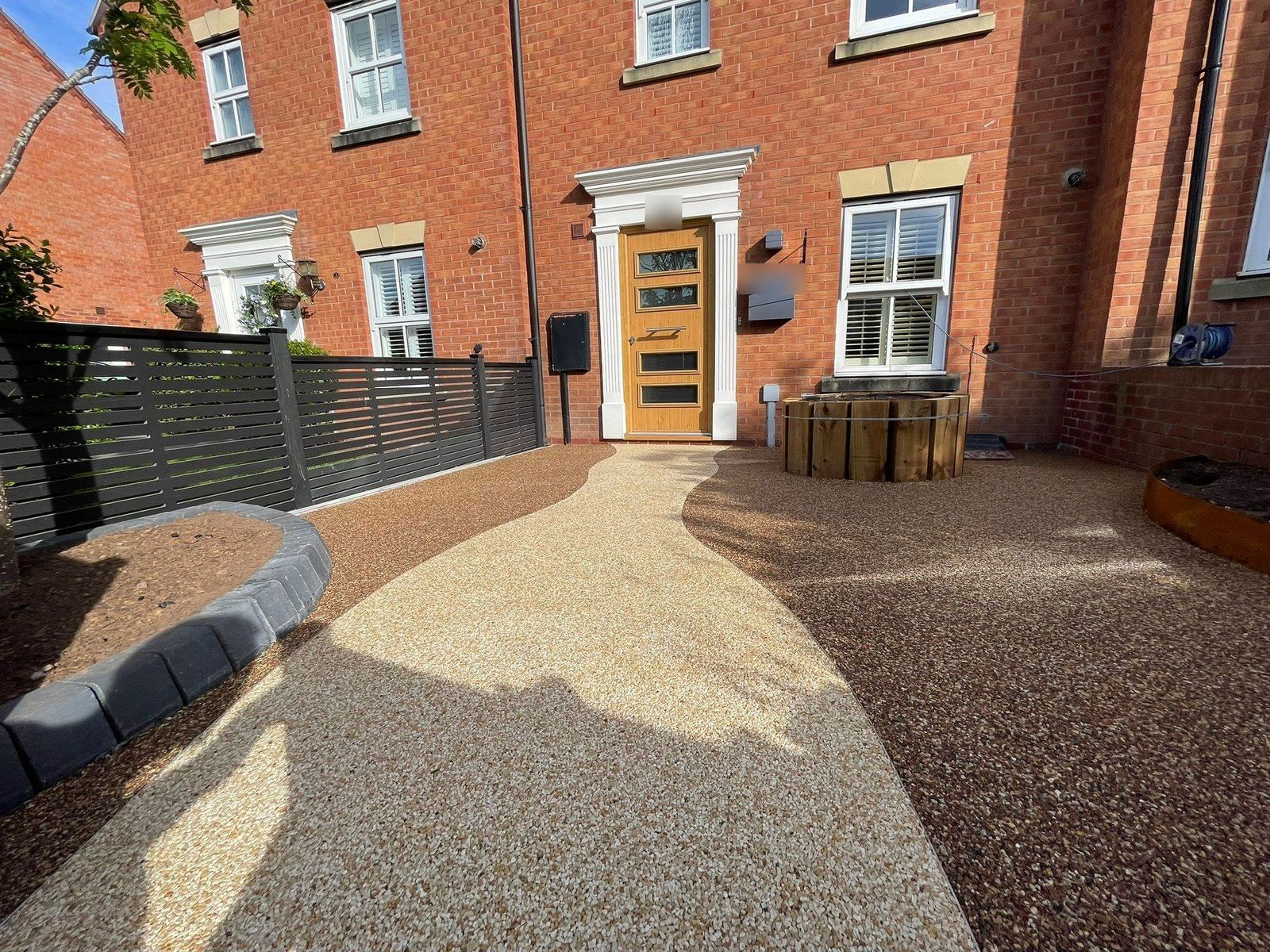 Two-tone resin bound front garden in Warwick, with a pale golden path curving to the front door