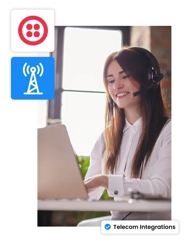 A woman wearing a headset is sitting in front of a laptop computer.