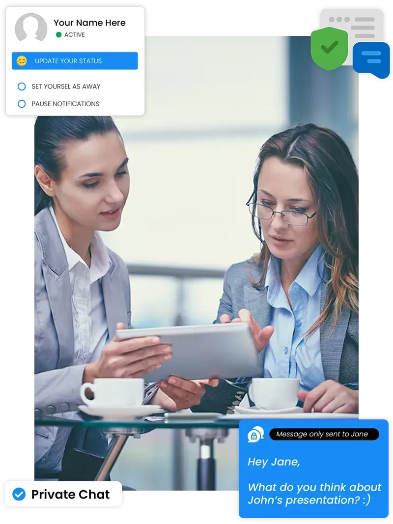 Two women are sitting at a table looking at a tablet.