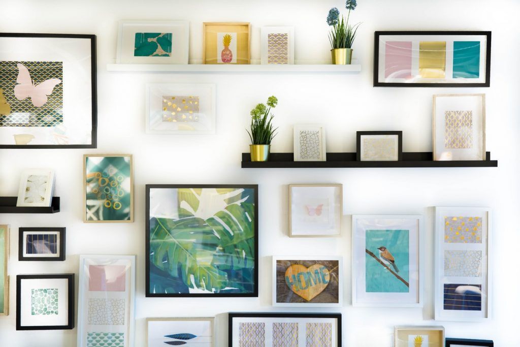 A wall filled with lots of pictures and shelves.