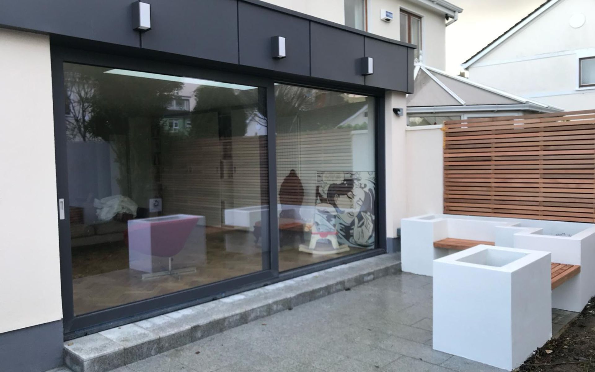 a house with a large sliding glass door leading to a patio .