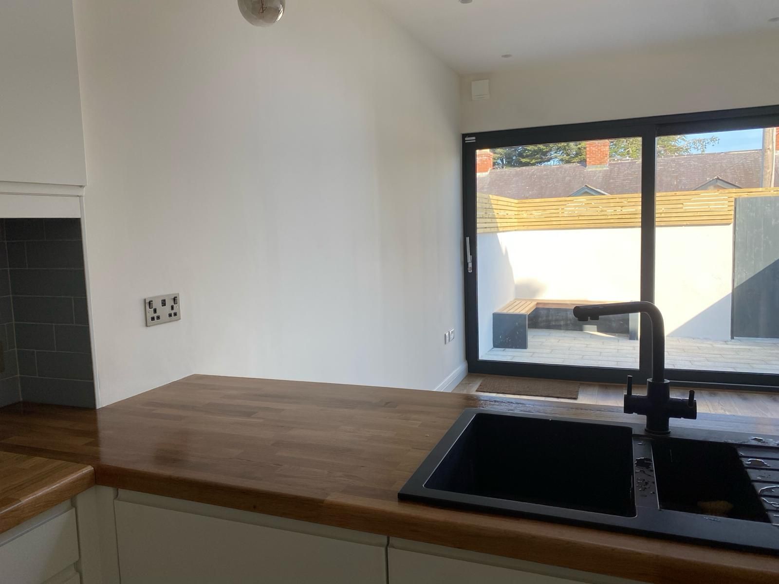 an empty kitchen with a sink and a window .
