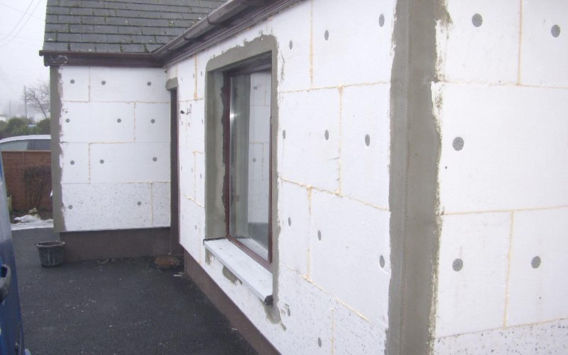 a house is being remodeled with styrofoam blocks and a window .